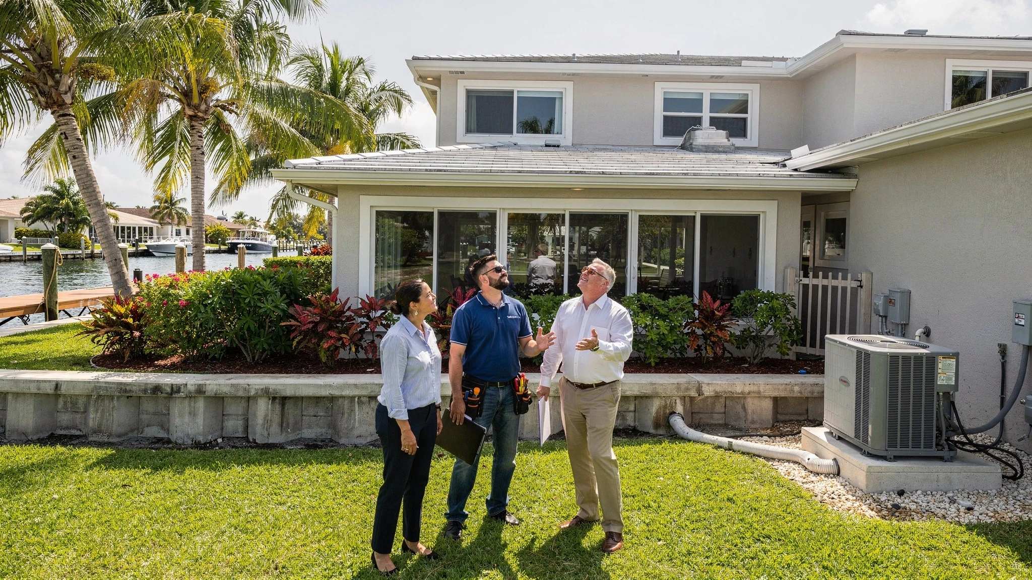 Buyer and professionals reviewing roof, drainage, exterior systems, seawall, and dock condition at a Fort Lauderdale property