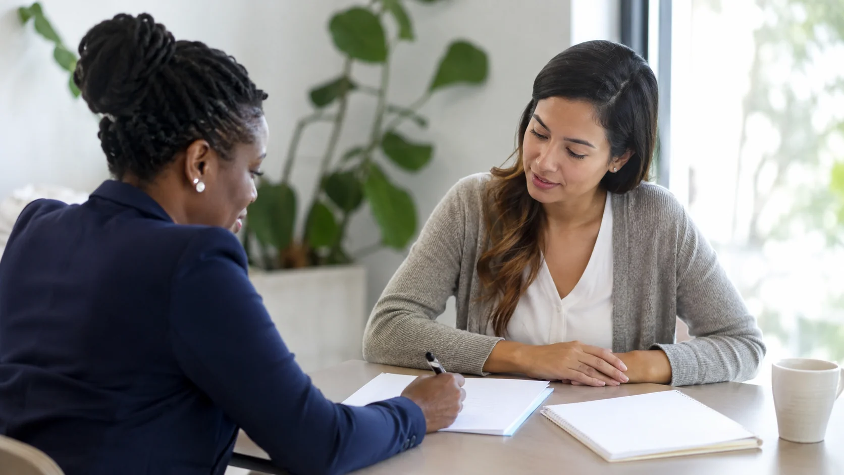 Homebuyer reviewing buyer assistance options with an advisor.