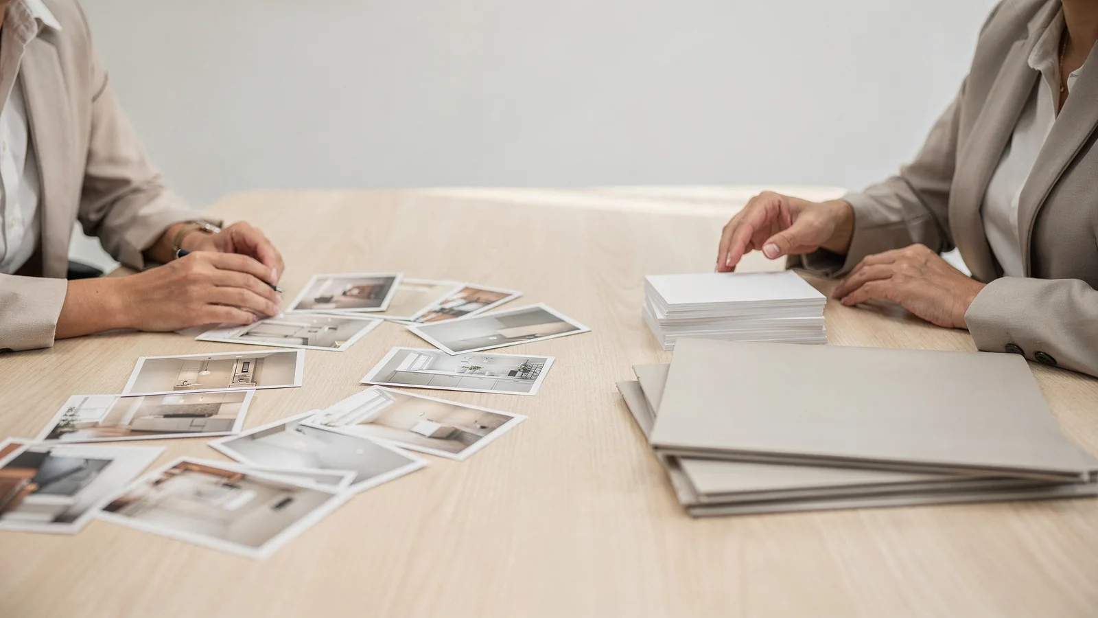 Homebuyer comparing property photos, blank notes, and a map during a listing review.