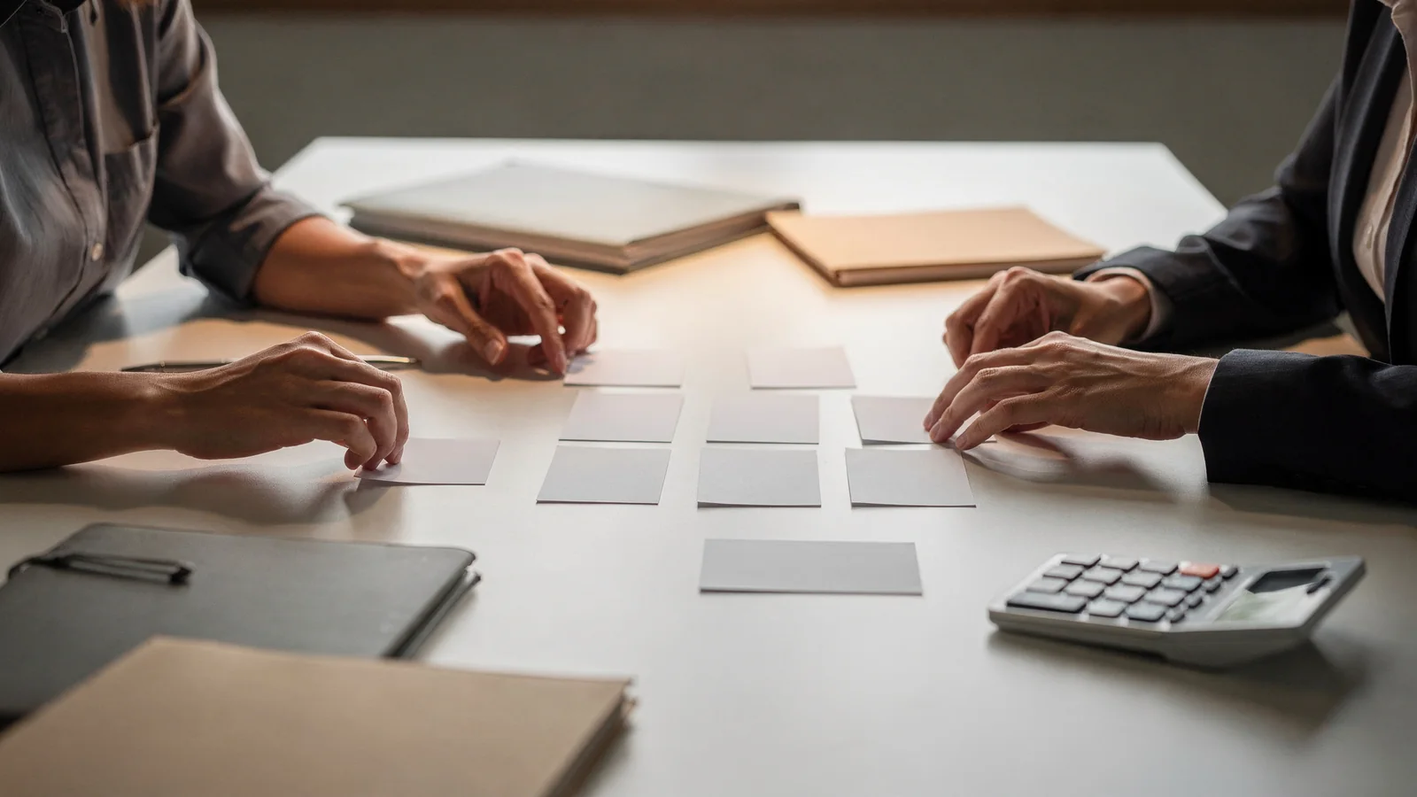 Homebuyer sorting blank decision cards for needs and wants.